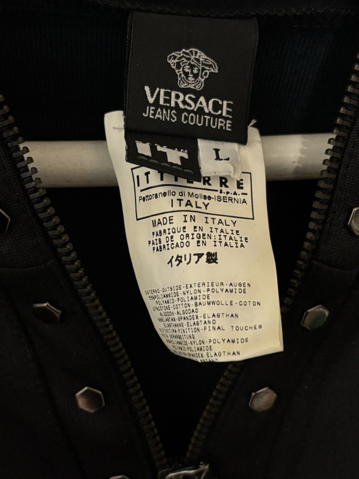 Black Versace hoodie with a half-zip and stud details.
