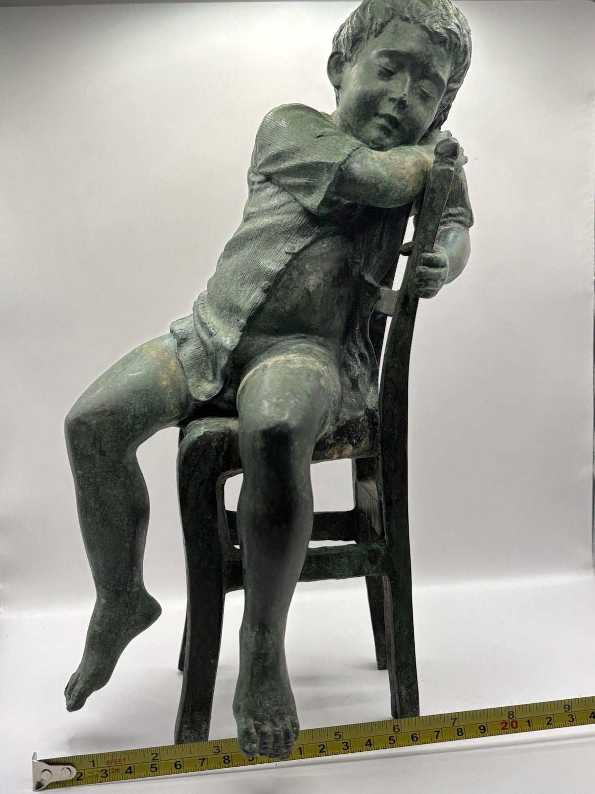 Maitland-Smith bronze boy in a chair, distinctive verde finish and brown patina.