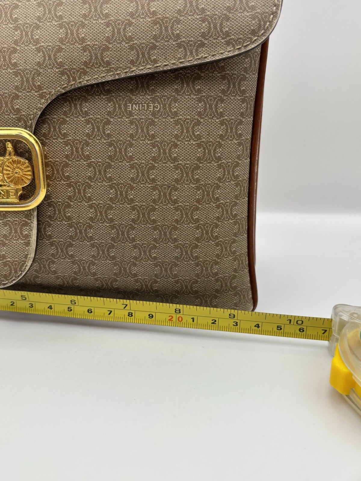 Celine Macadam leather top handle bag with a horse carriage logo buckle.