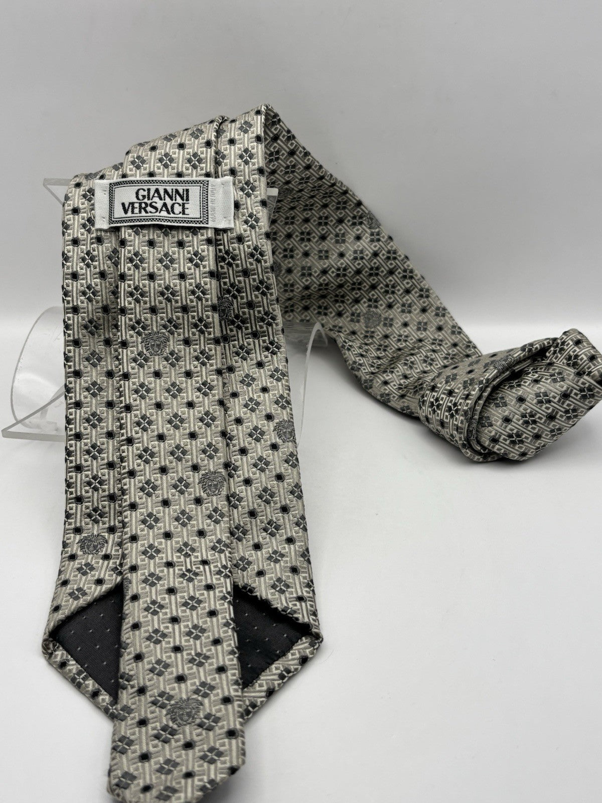 Versace tie silver and grey color with geometric pattern Medusa head logo.