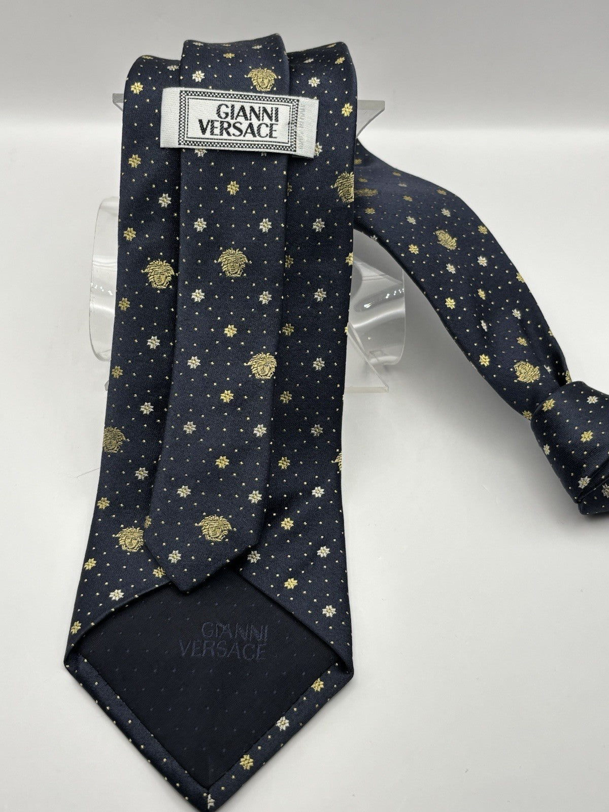 Navy blue Gianni Versace silk necktie gold Medusa head and diamond pattern.