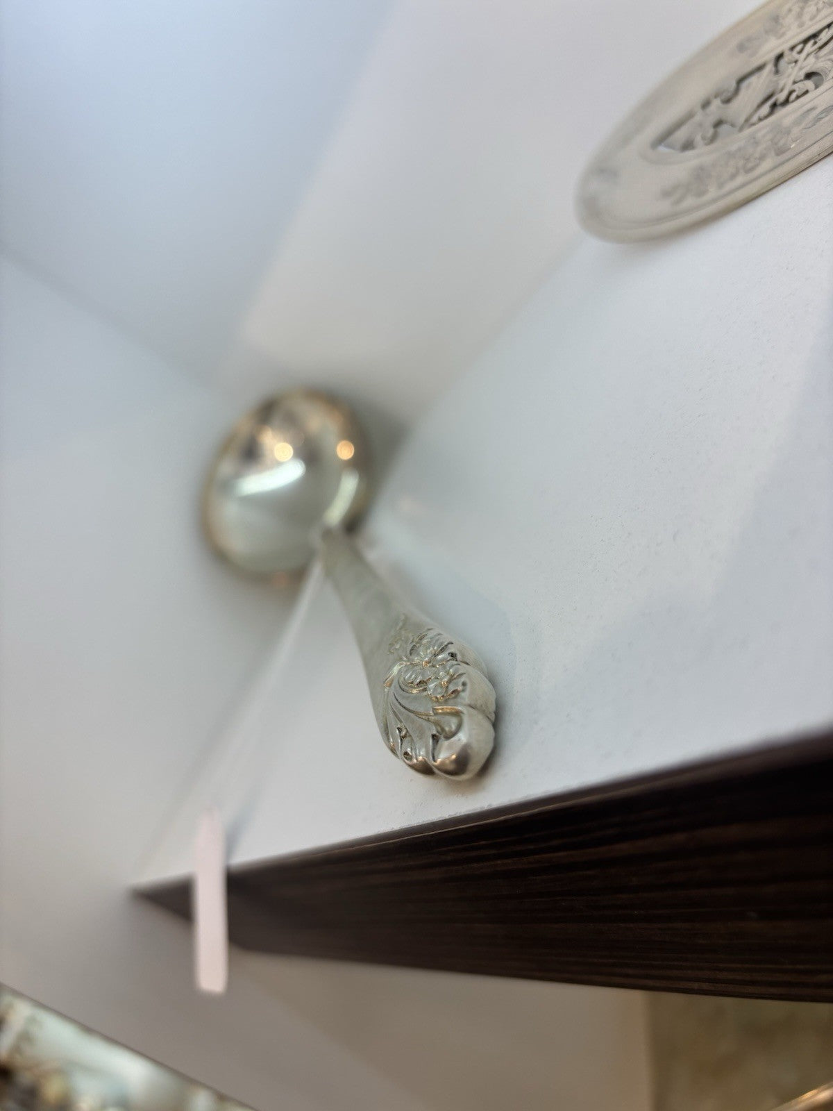 Vintage spoon with a traced design of beautiful flowers on the handle