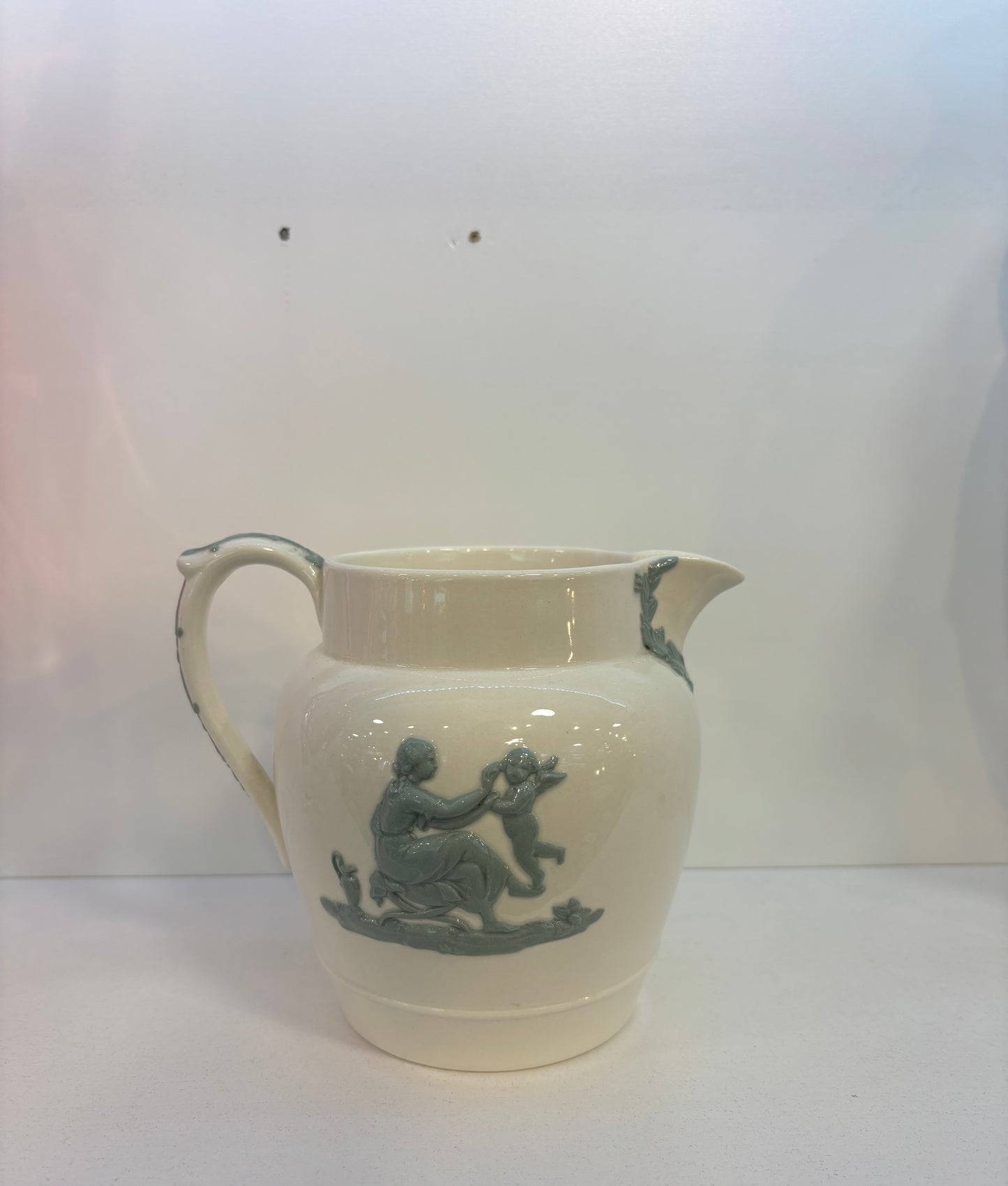 WEDGWOOD OF ETRURIA & BARLASTON EMBOSSED QUEENSWARE BLUE ON CREAM PITCHER