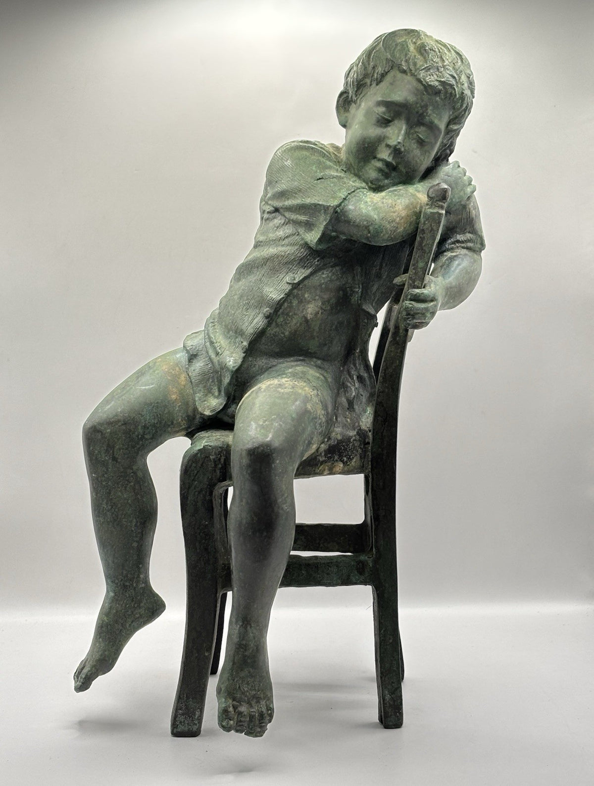Maitland-Smith bronze boy in a chair, distinctive verde finish and brown patina.