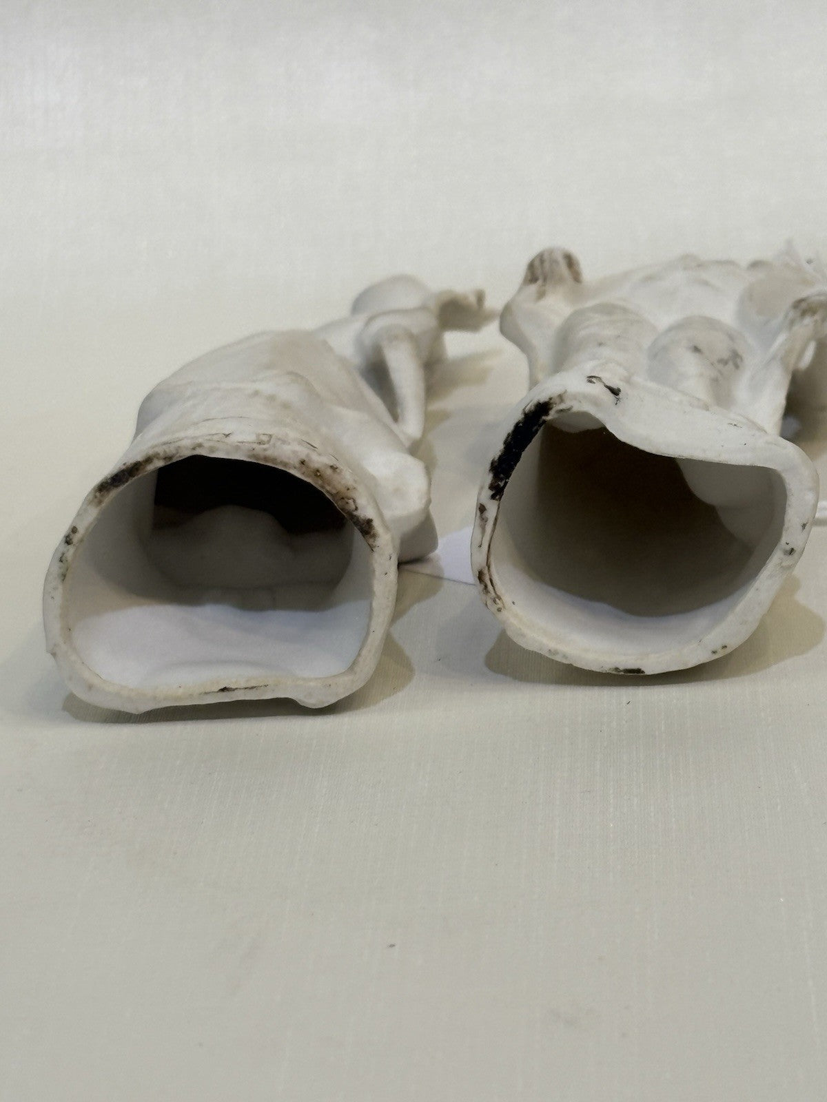 pair of vintage bisque porcelain figurines depicting a Victorian style couple