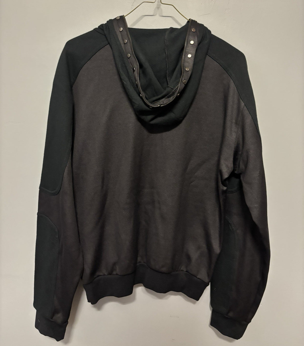 Black Versace hoodie with a half-zip and stud details.