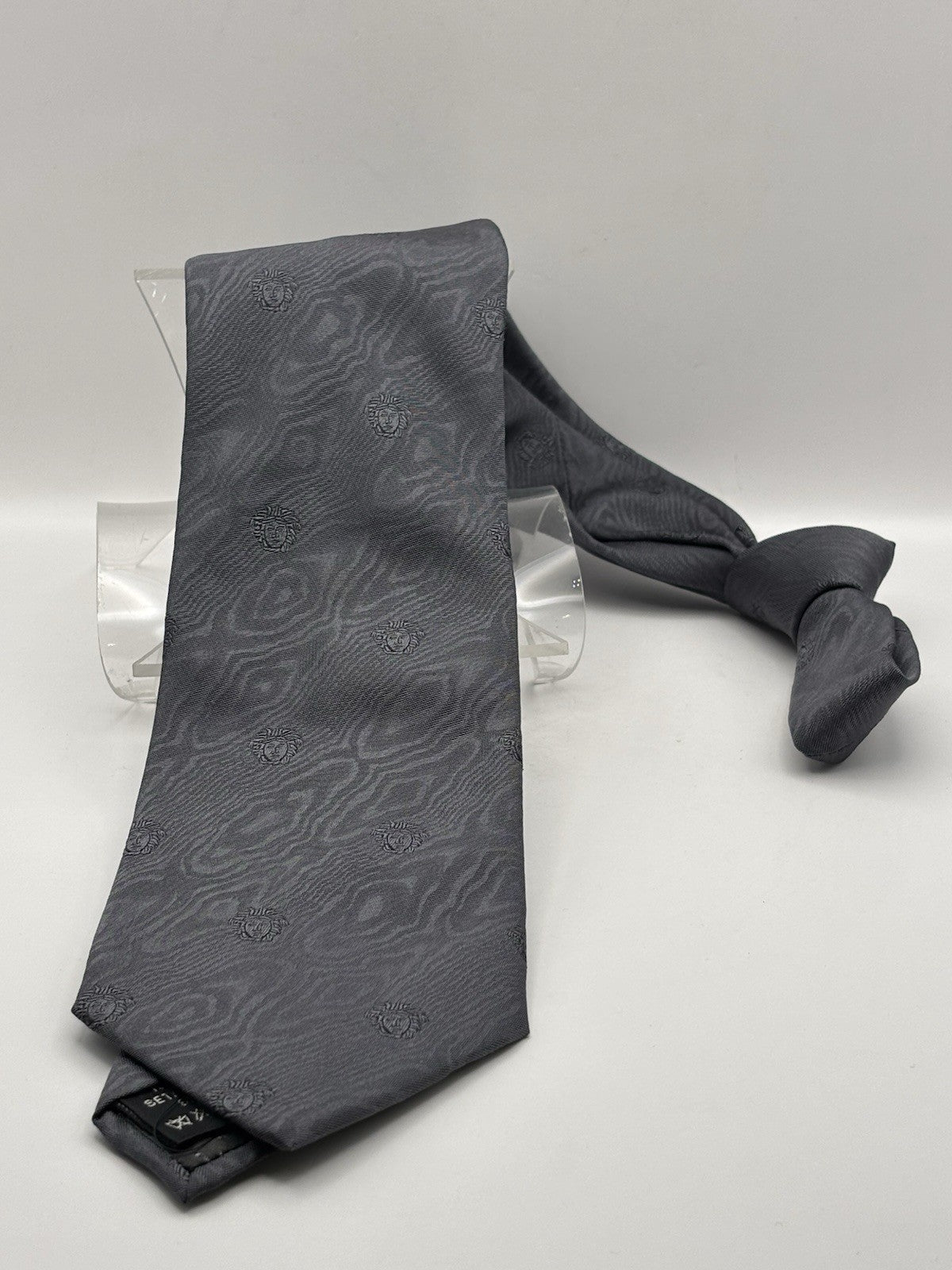 Versace tie gray geometric pattern with the iconic Medusa head logo.