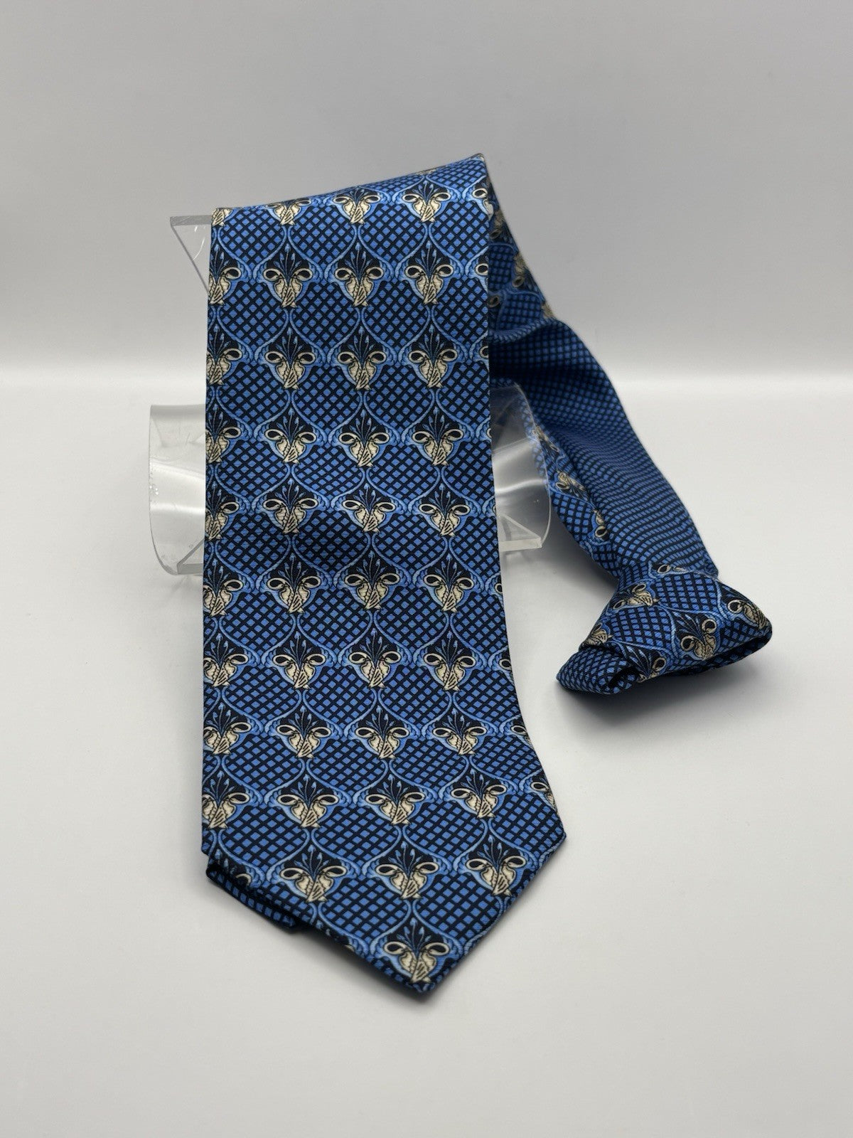 blue Versace necktie made In Italian silk and features a geometric pattern.