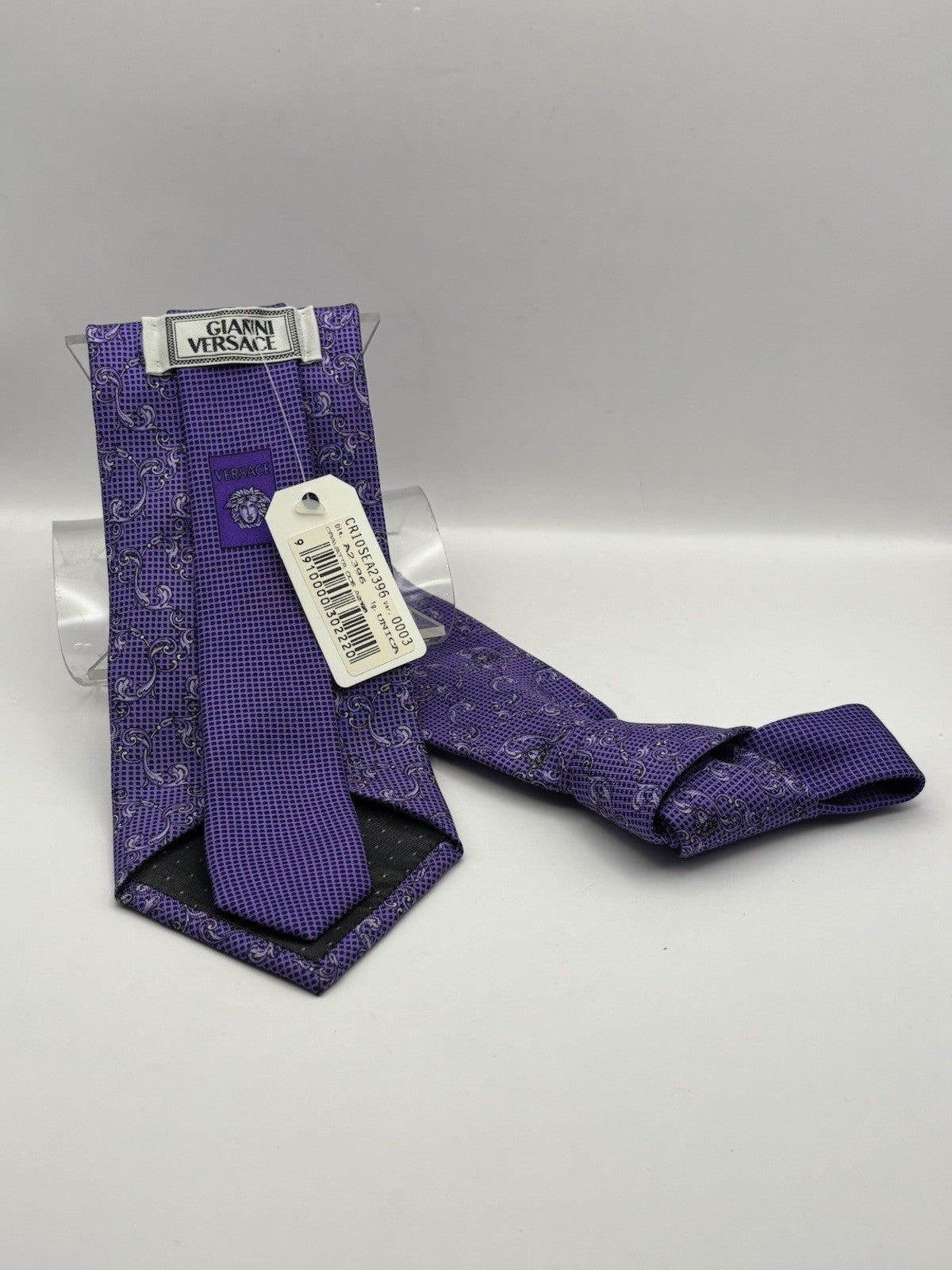 Versace tie vibrant purple, black and white paisley-style Medusa head logo.