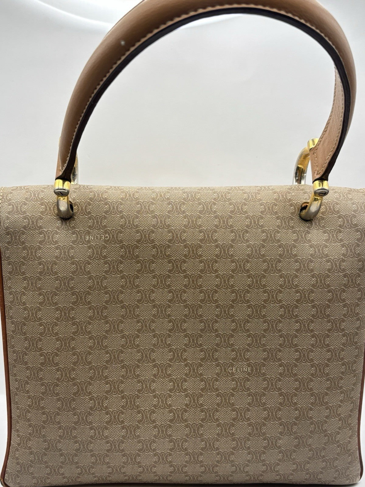 Celine Macadam leather top handle bag with a horse carriage logo buckle.