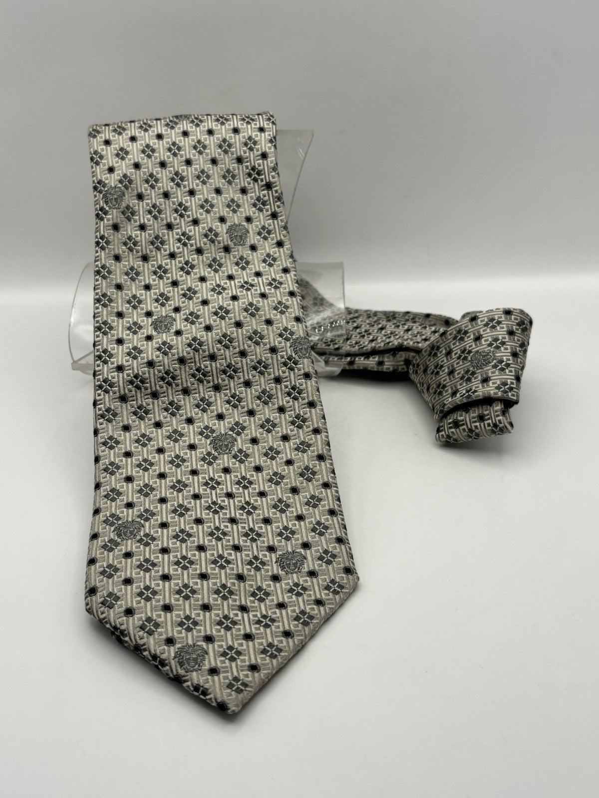 Versace tie silver and grey color with geometric pattern Medusa head logo.