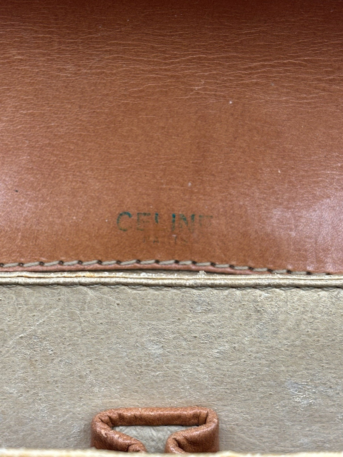 Celine Macadam leather top handle bag with a horse carriage logo buckle.