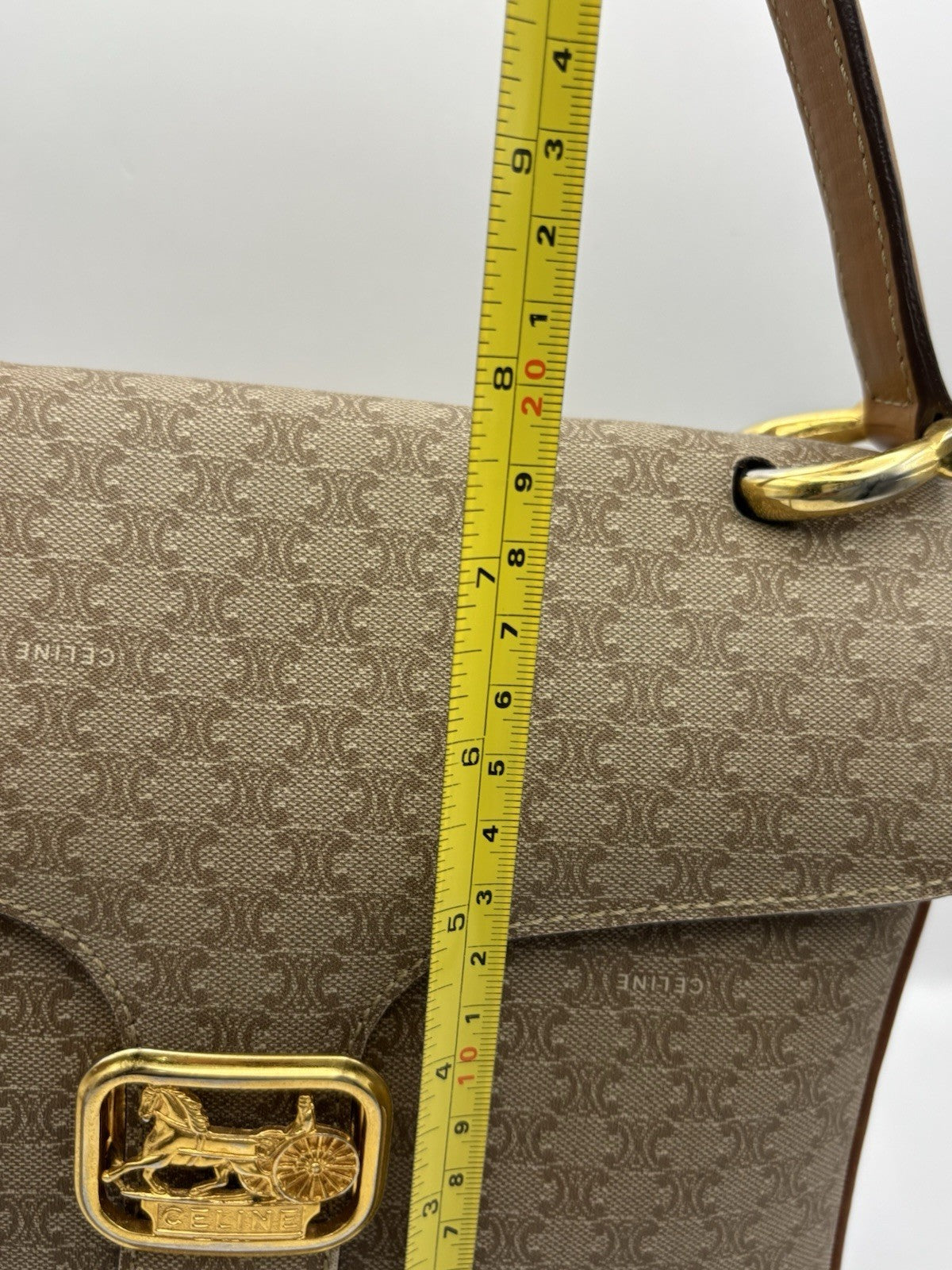 Celine Macadam leather top handle bag with a horse carriage logo buckle.