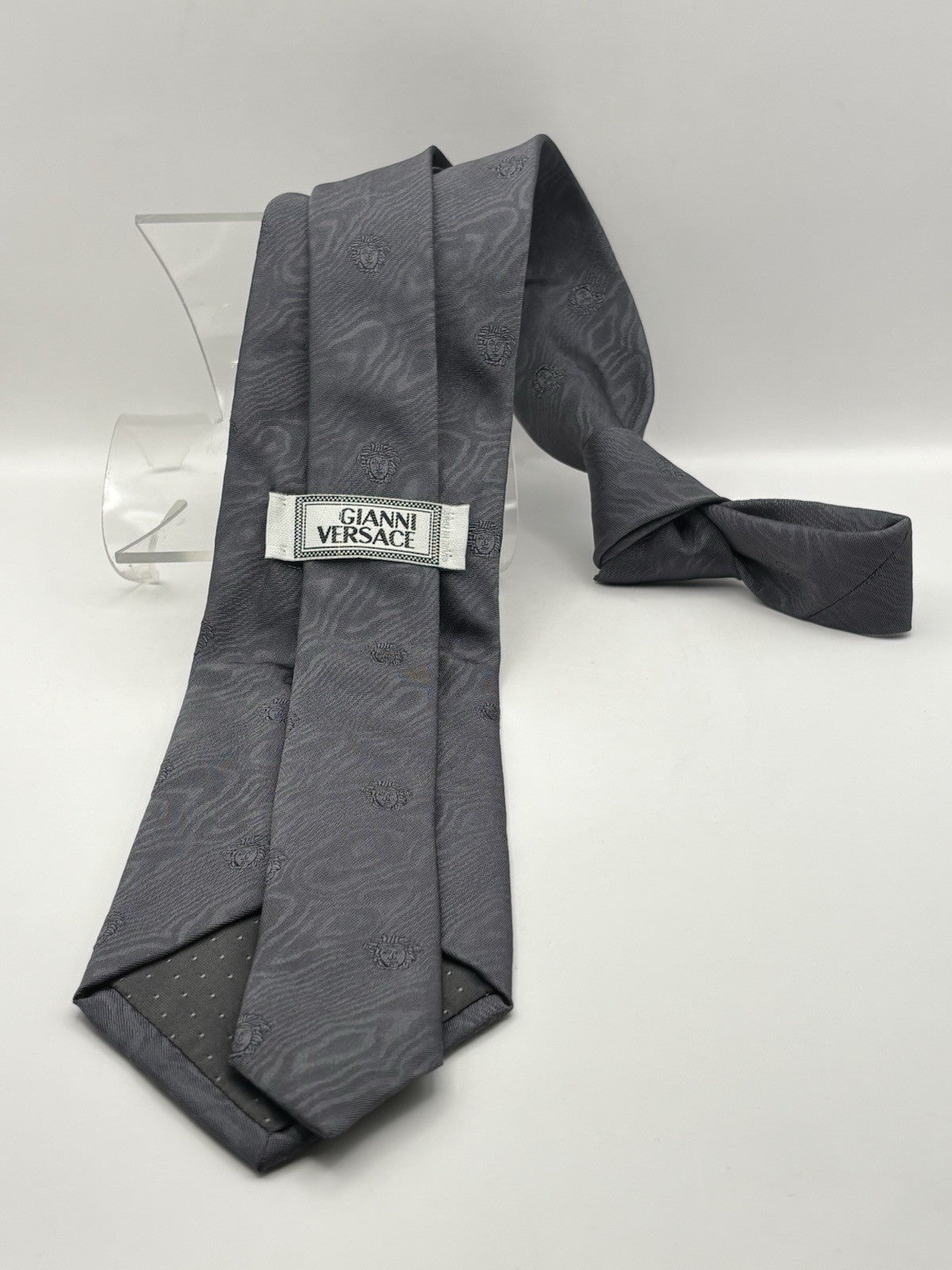 Versace tie gray geometric pattern with the iconic Medusa head logo.