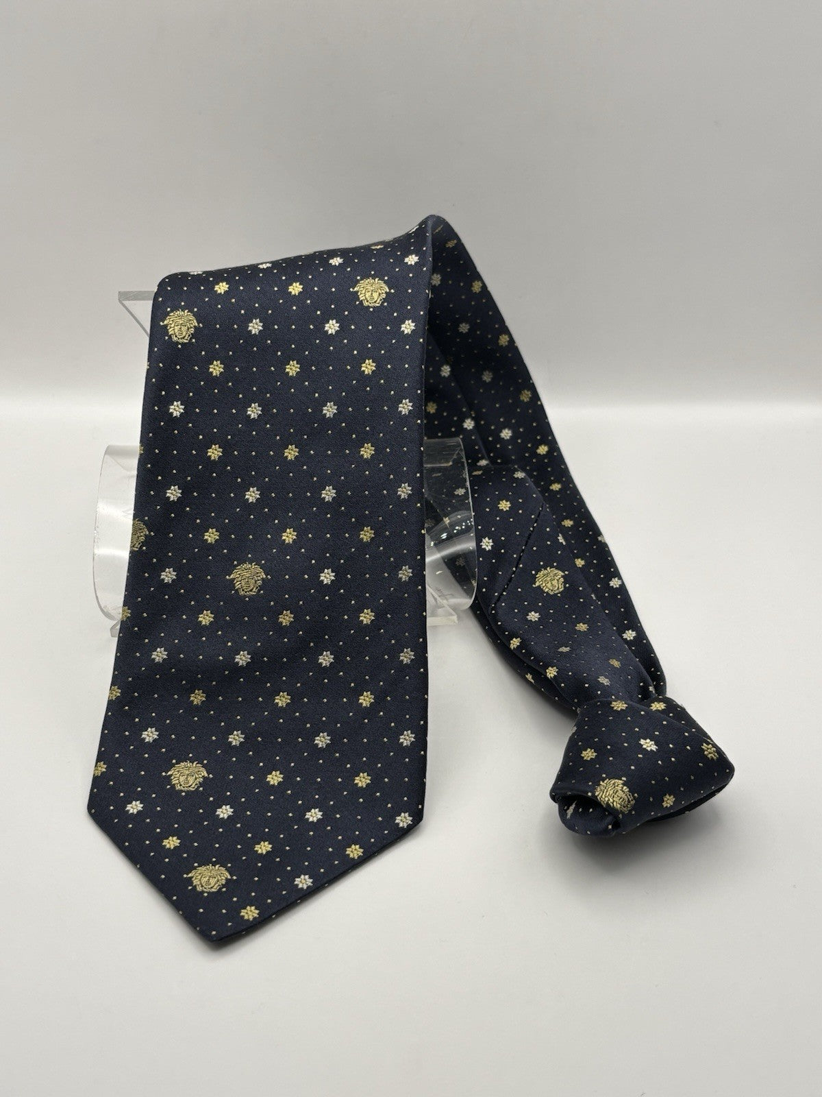 Navy blue Gianni Versace silk necktie gold Medusa head and diamond pattern.