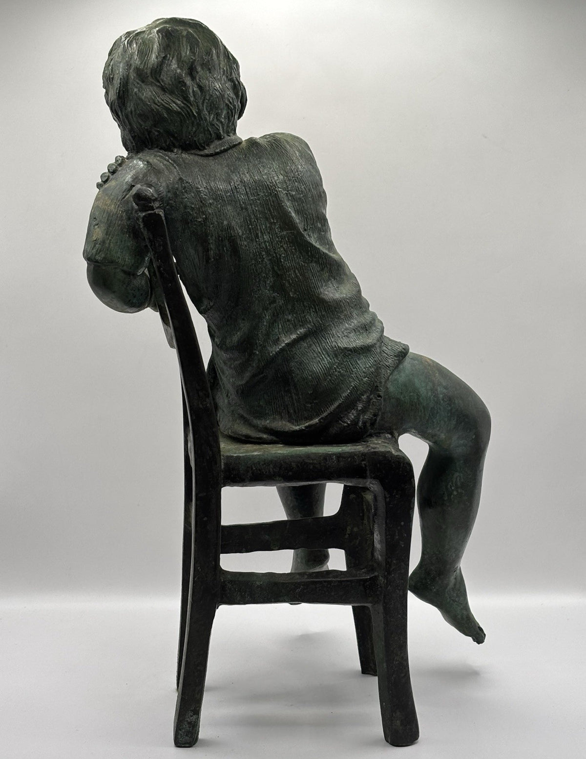 Maitland-Smith bronze boy in a chair, distinctive verde finish and brown patina.