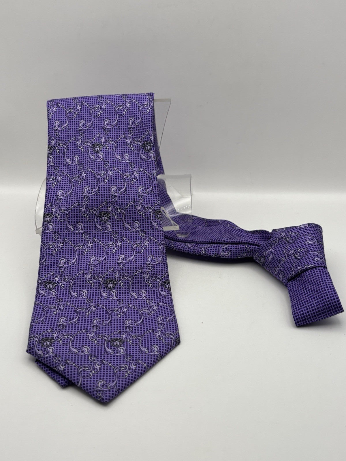 Versace tie vibrant purple, black and white paisley-style Medusa head logo.