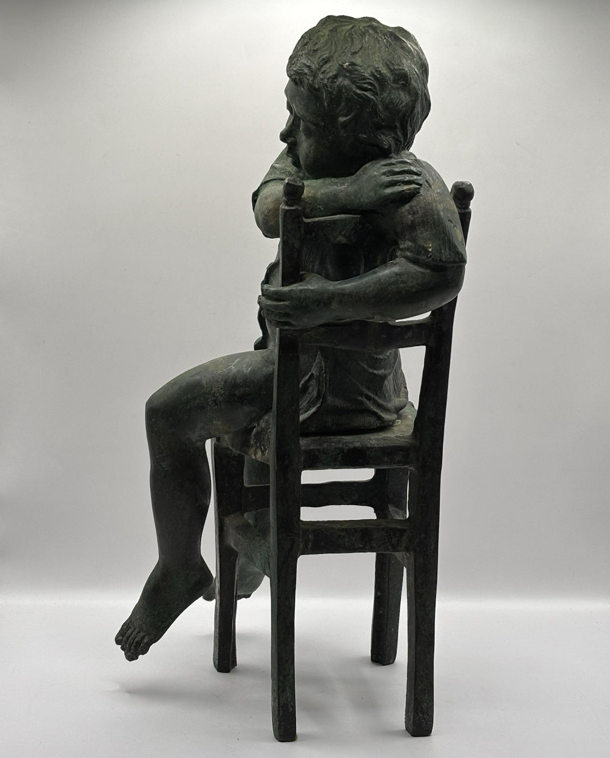 Maitland-Smith bronze boy in a chair, distinctive verde finish and brown patina.