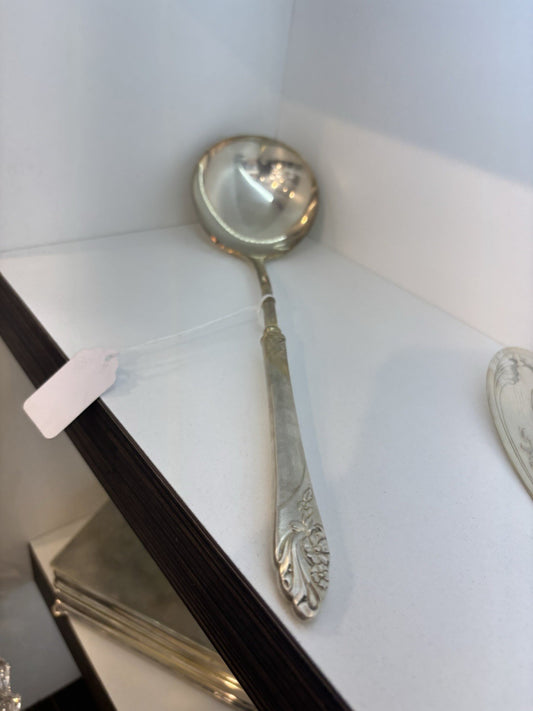 Vintage spoon with a traced design of beautiful flowers on the handle