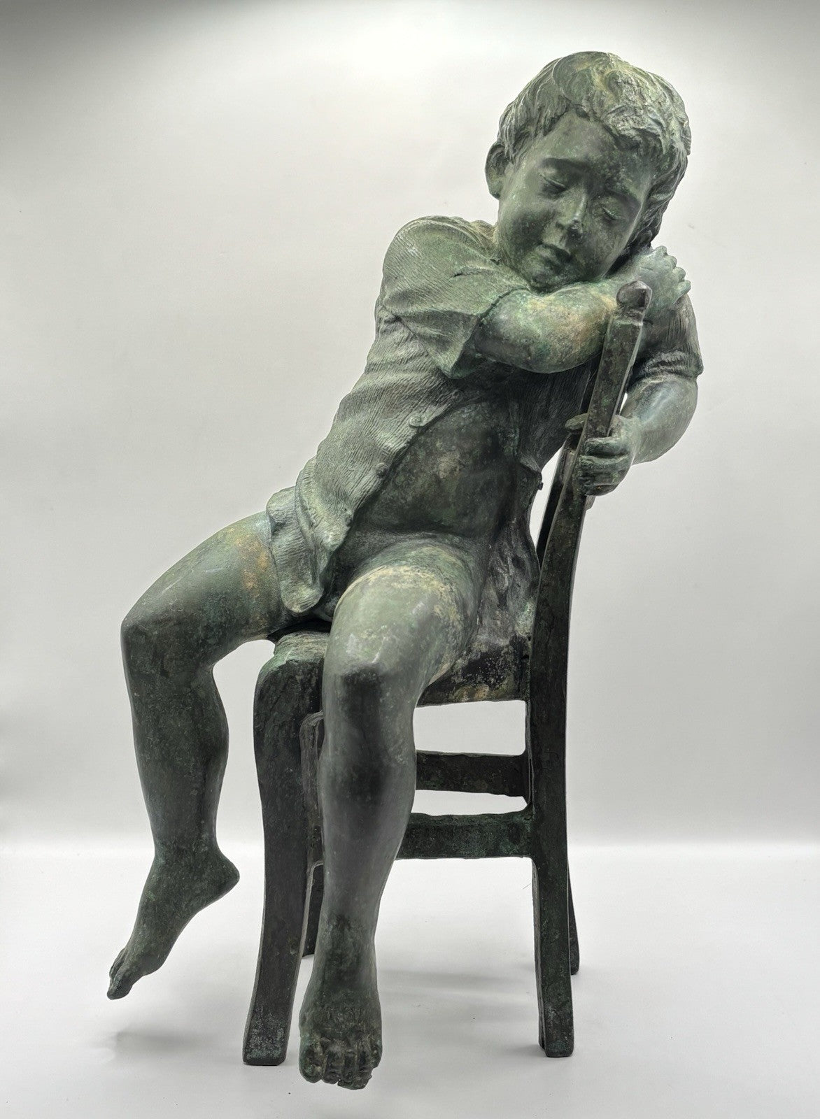 Maitland-Smith bronze boy in a chair, distinctive verde finish and brown patina.